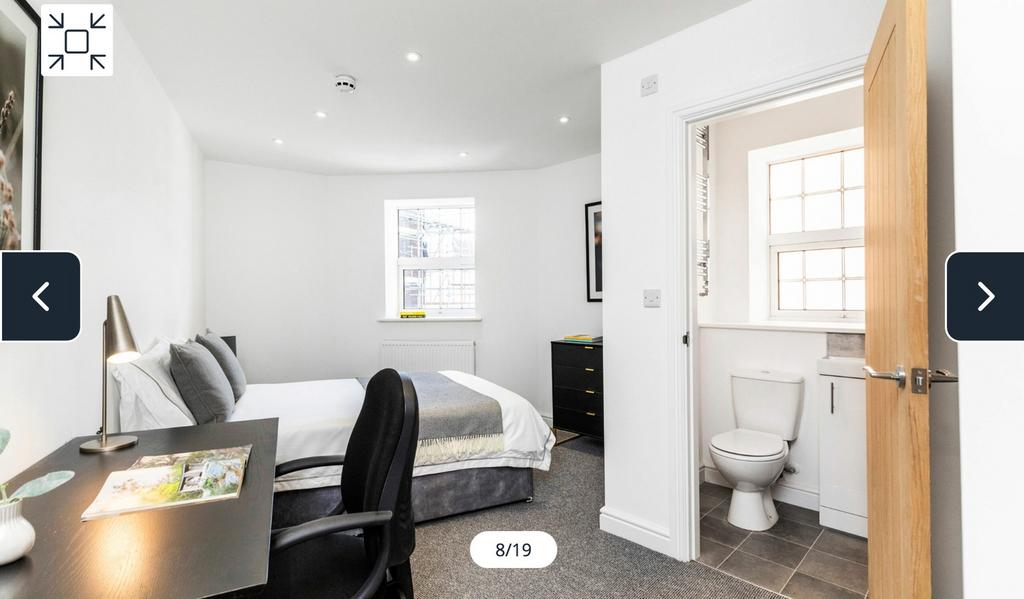 A spacious and well-lit double bedroom featurin...