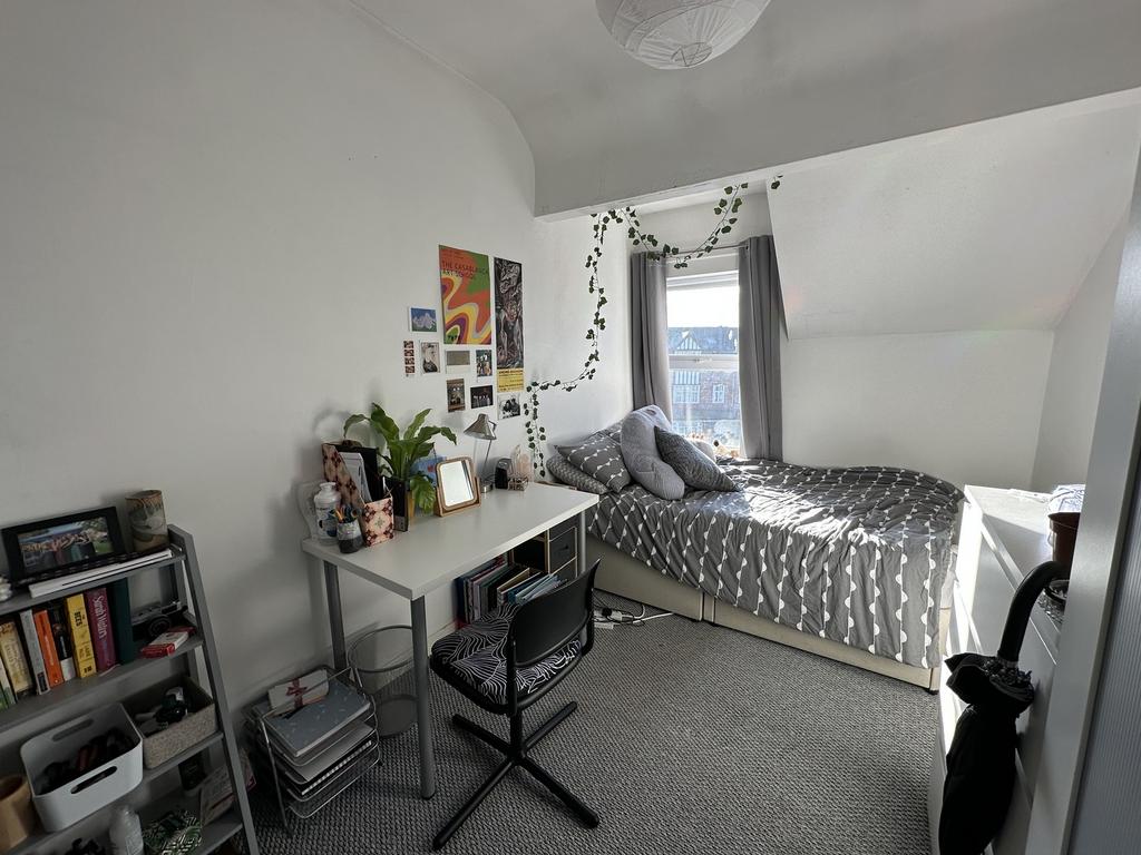 A bright and inviting double bedroom featuring ...