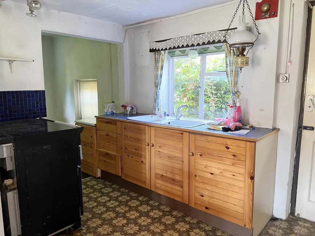 Kitchen with window to garden and utility room bey