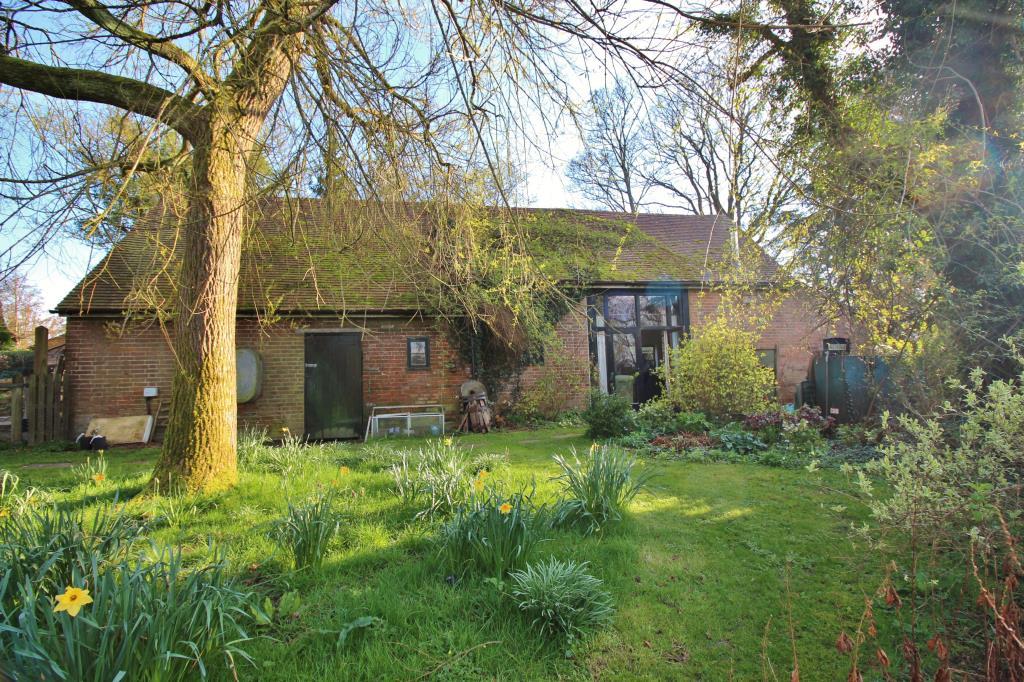 Rear view of the exteriors of the barn with garden