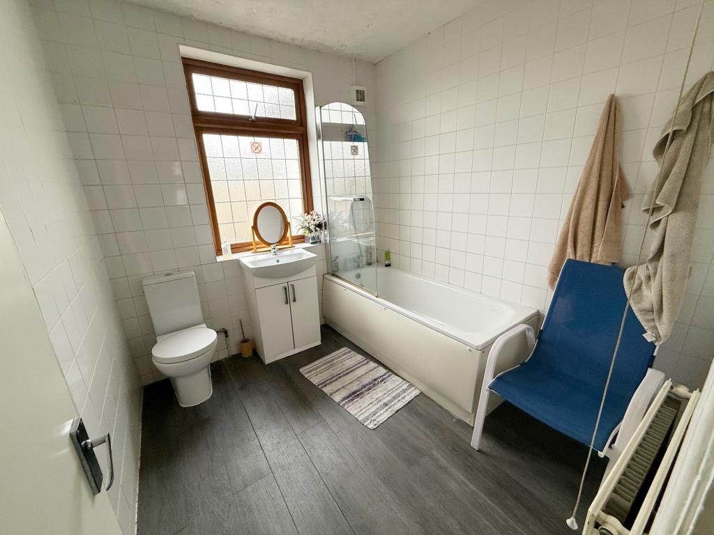 Bath, sink, w/c and window to rear aspect