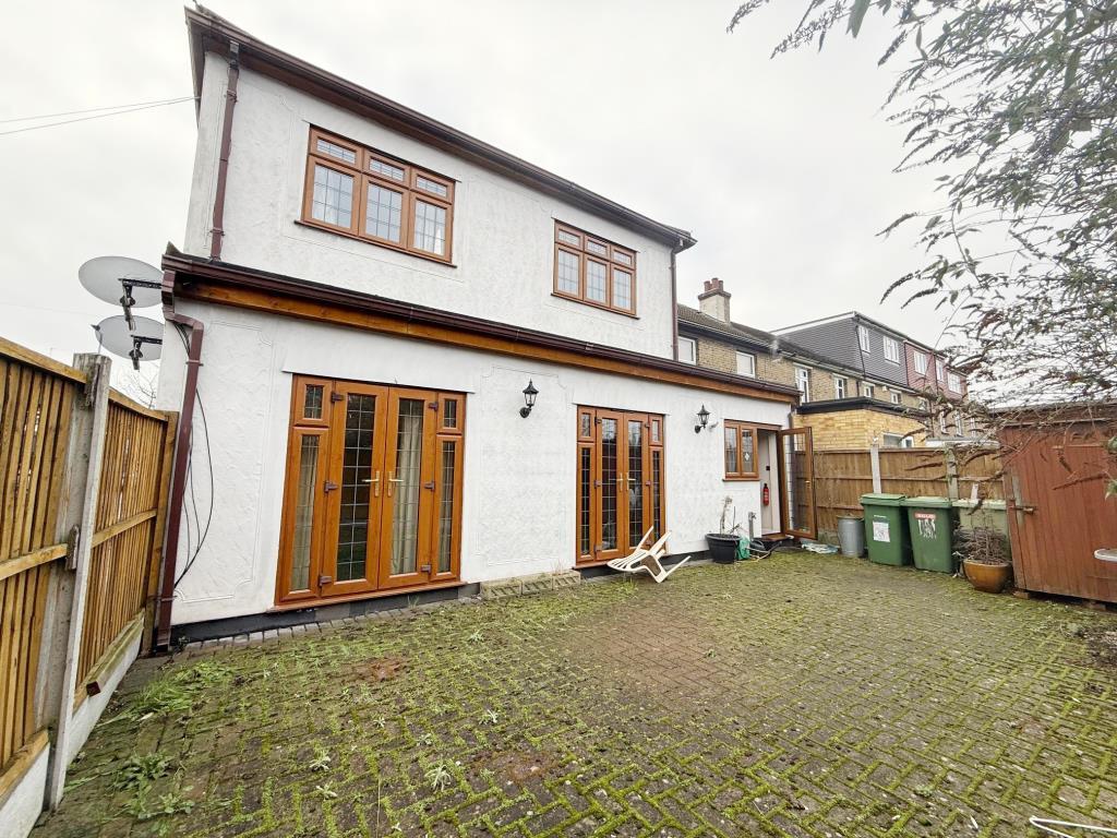 Block paved garden area with French doors leading