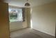 Bedroom with radiator and window looking out to re