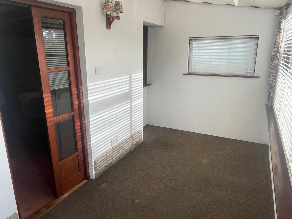 Conservatory with doorway leading to living/dining