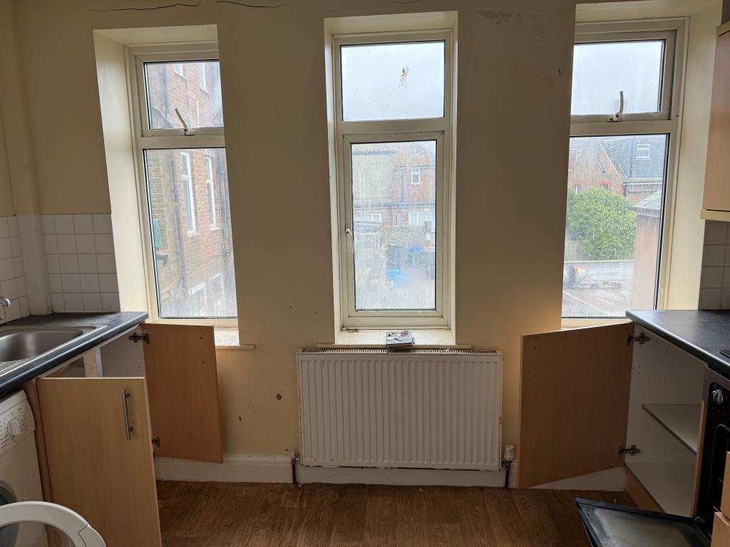 Kitchen at rea with windows and units