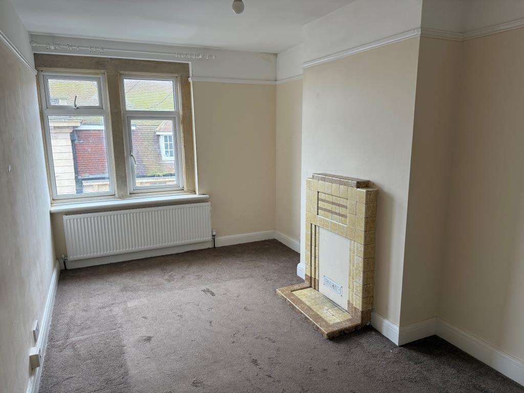 Main bedroom at front with window and fireplace