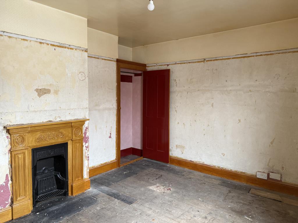 Bedroom with plastered walls and fireplace