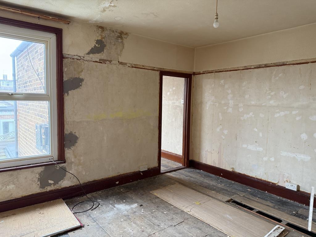 Bedroom two with entrance to bedroom three in back