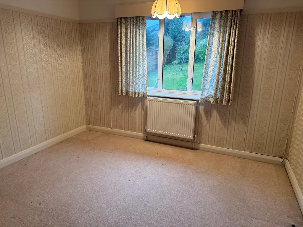 Second bedroom with window to rear