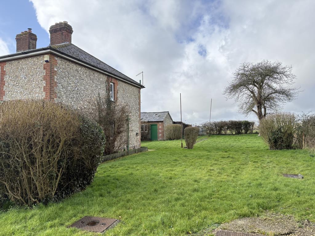 View of side plot and parking with fields beyond