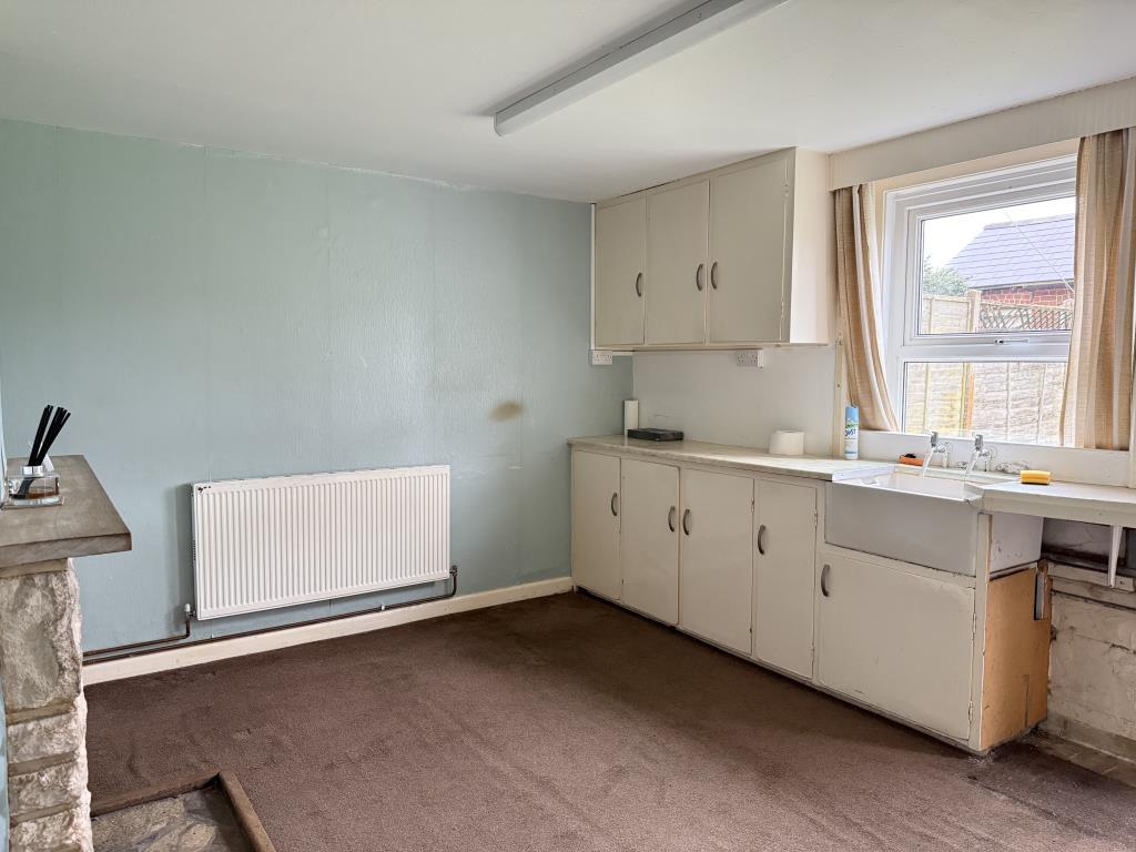 Kitchen with fitted units and window to garden