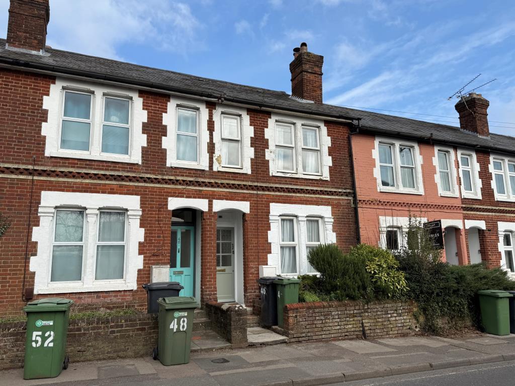 Mid-terrace house with brick elevation and painted