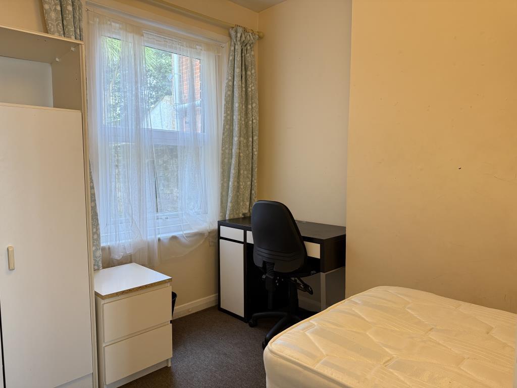 Ground floor rear room with bedroom furniture