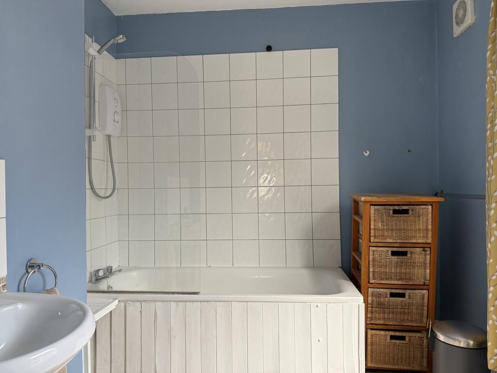 First floor bathroom with white tiles and painted