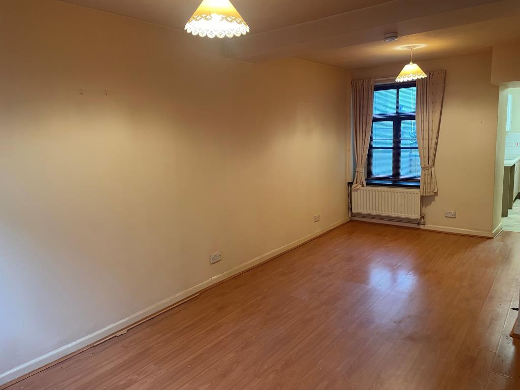Living room with radiator and window looking on re