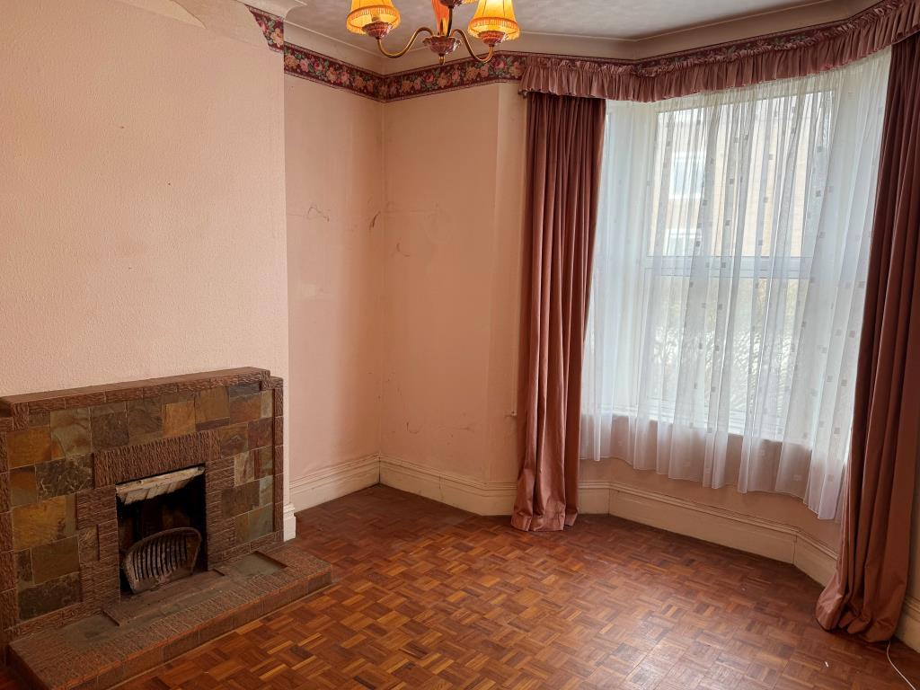 GF Living room to front with window and fireplace