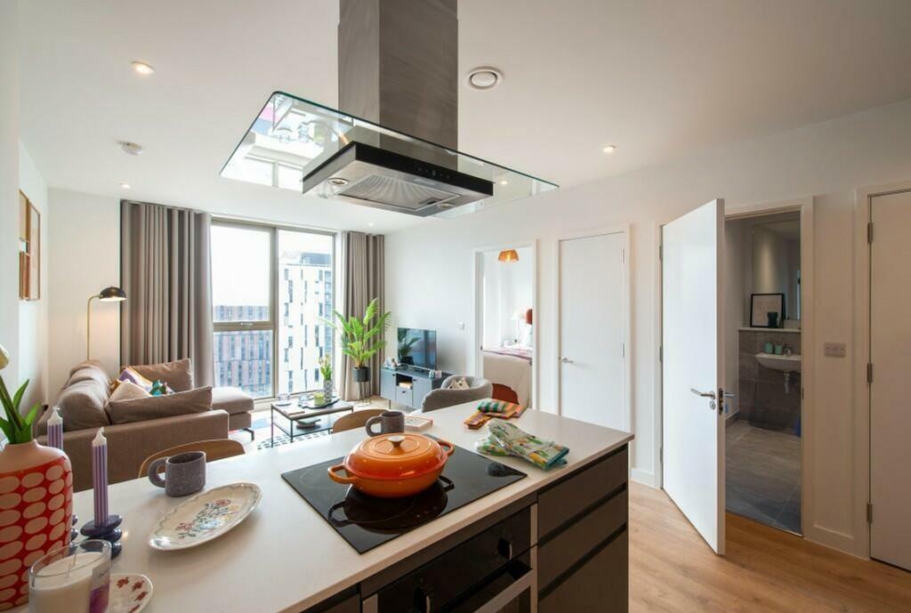 A spacious and well-lit modern living room with...