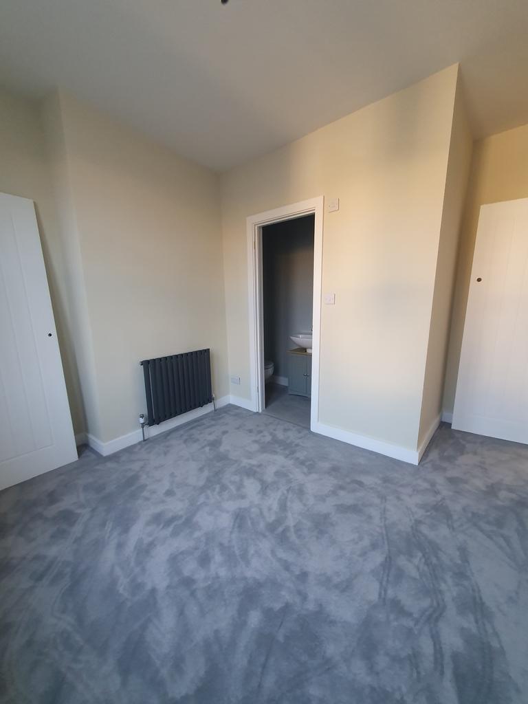 A spacious and inviting double bedroom with amp...