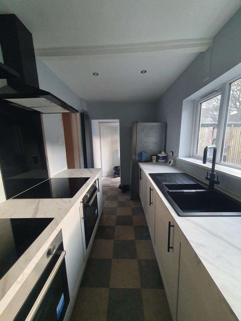 A modern kitchen featuring ample counter space ...