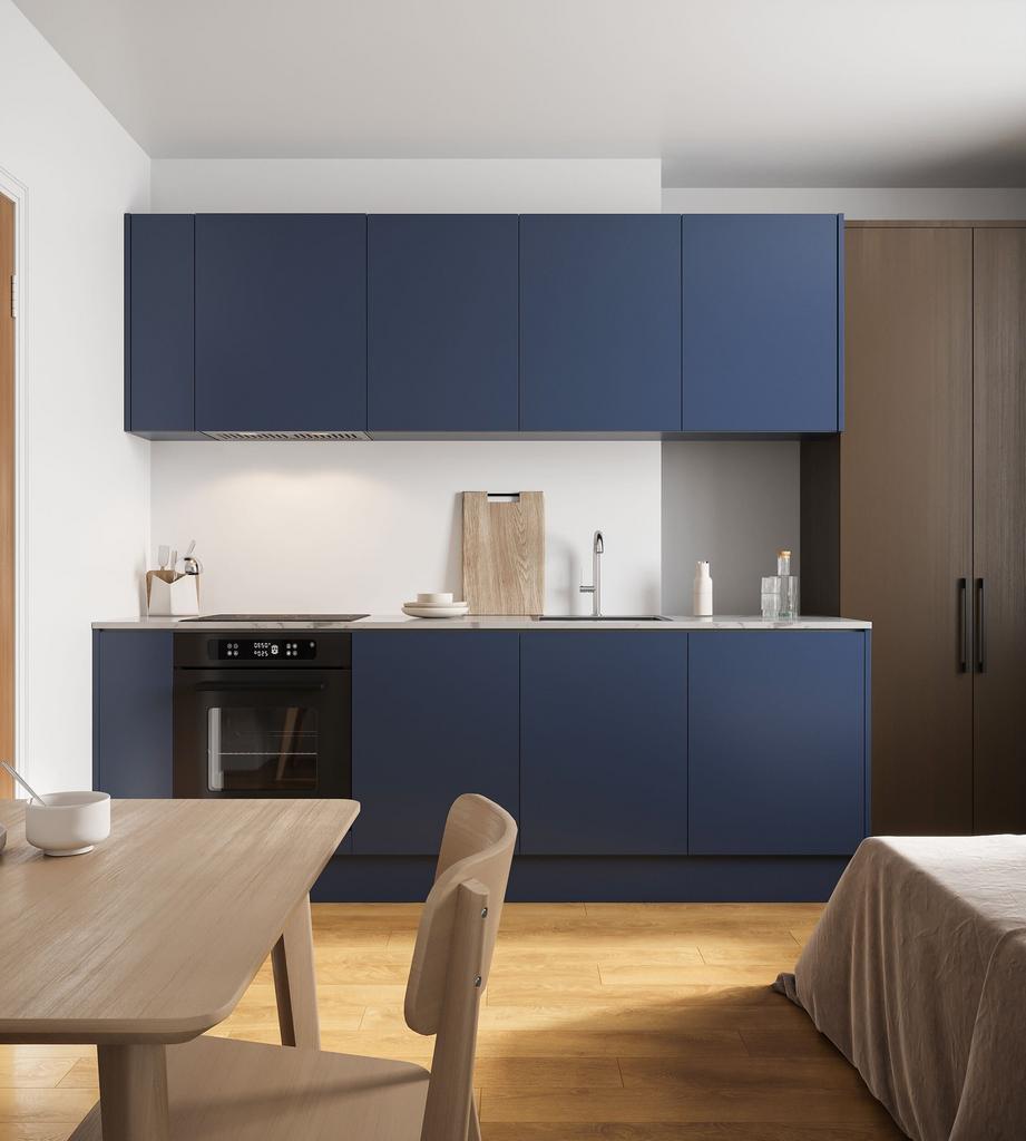 A modern and clean kitchen featuring blue cabin...