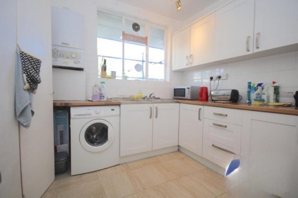 A bright and tidy kitchenette featuring modern ...