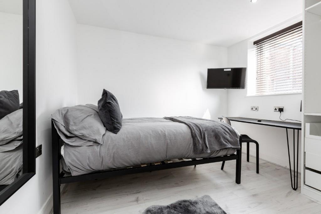 A stylish and inviting double bedroom with ampl...