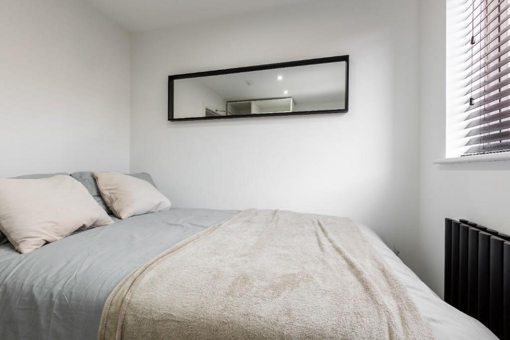 A cozy and inviting double bedroom featuring a ...