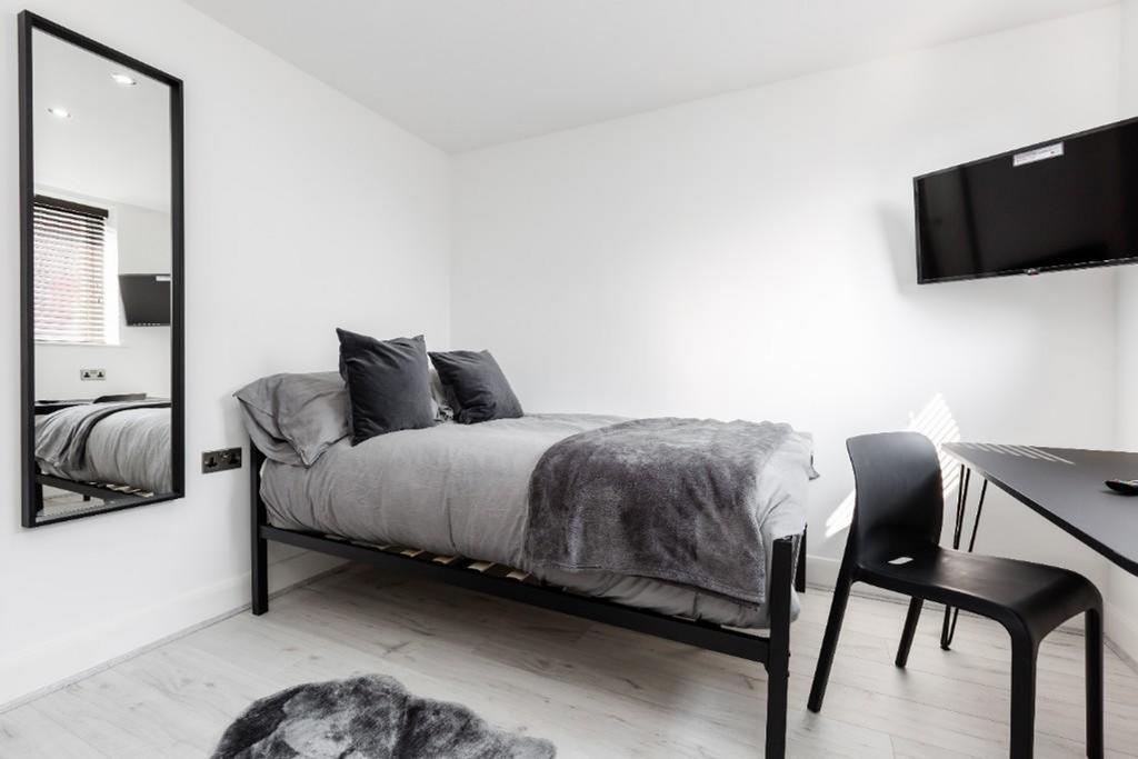 A bright and stylish double bedroom featuring m...