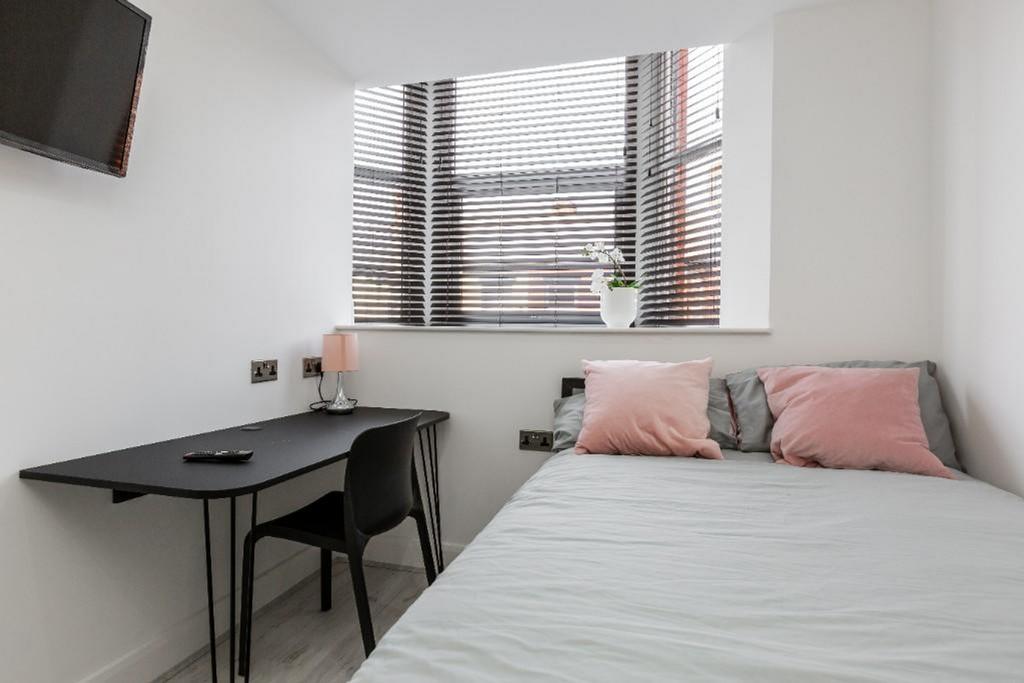 A bright and modern double bedroom featuring a ...