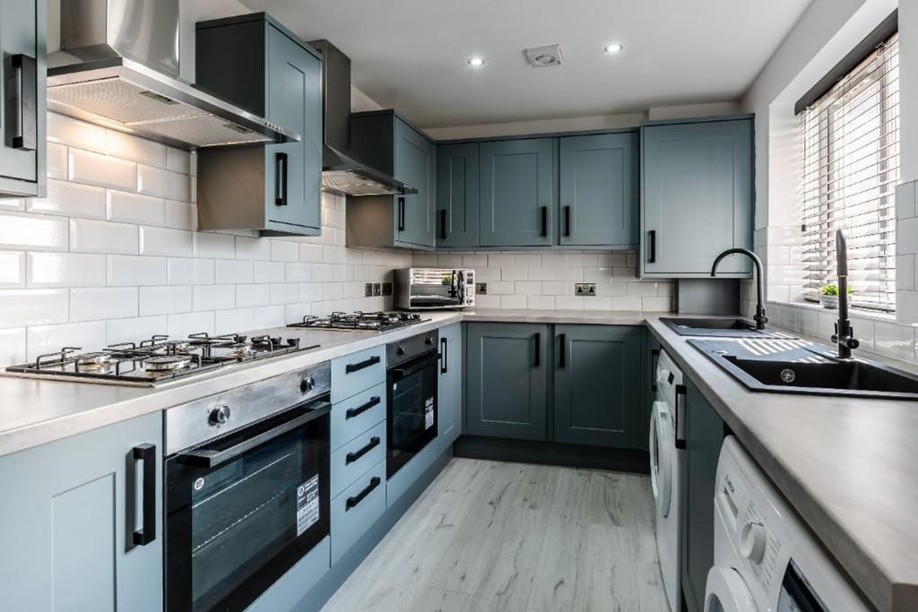 A modern and well-equipped kitchen featuring sl...