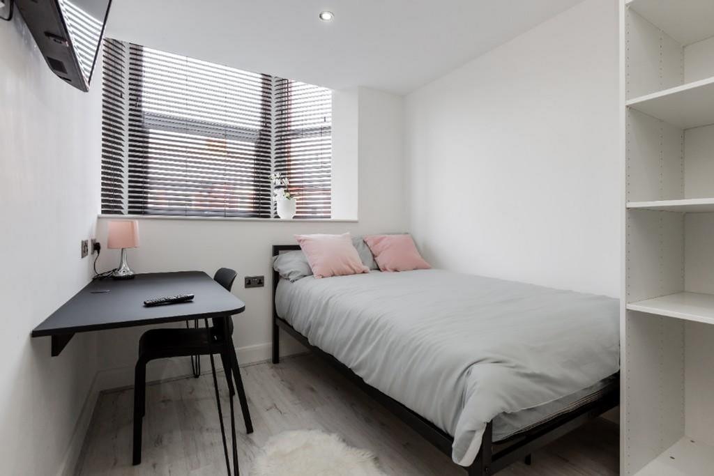 A bright and modern double bedroom with a cozy ...