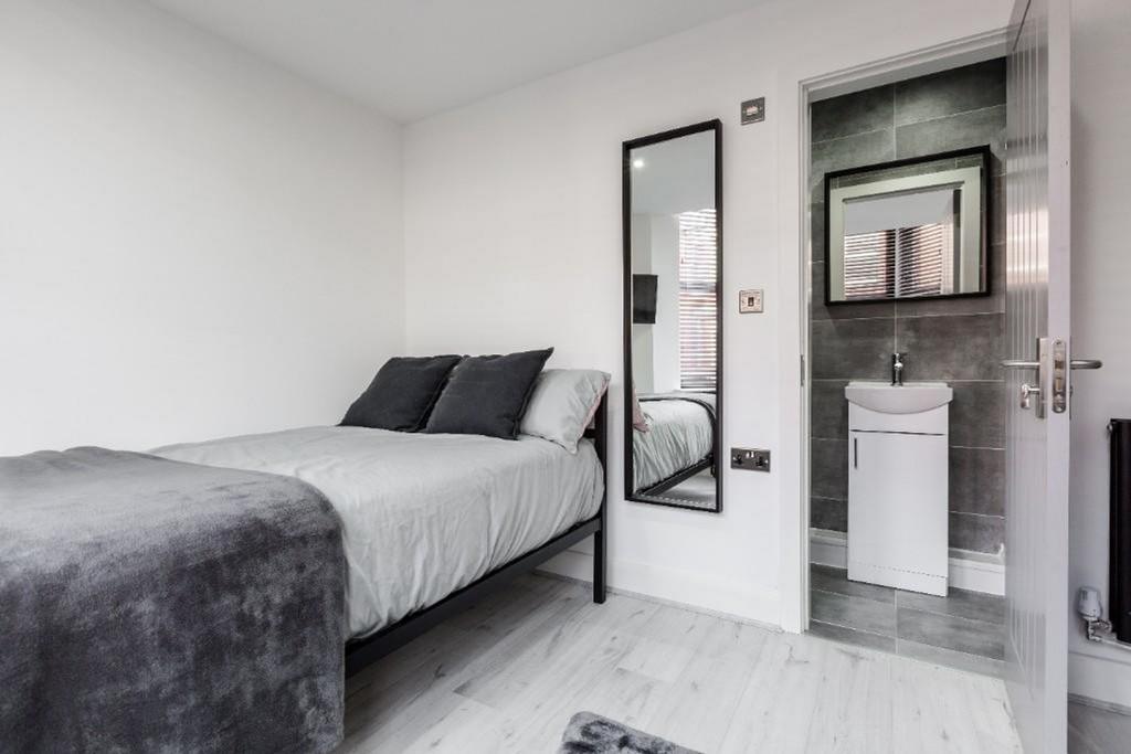 A bright and tidy double bedroom featuring a co...