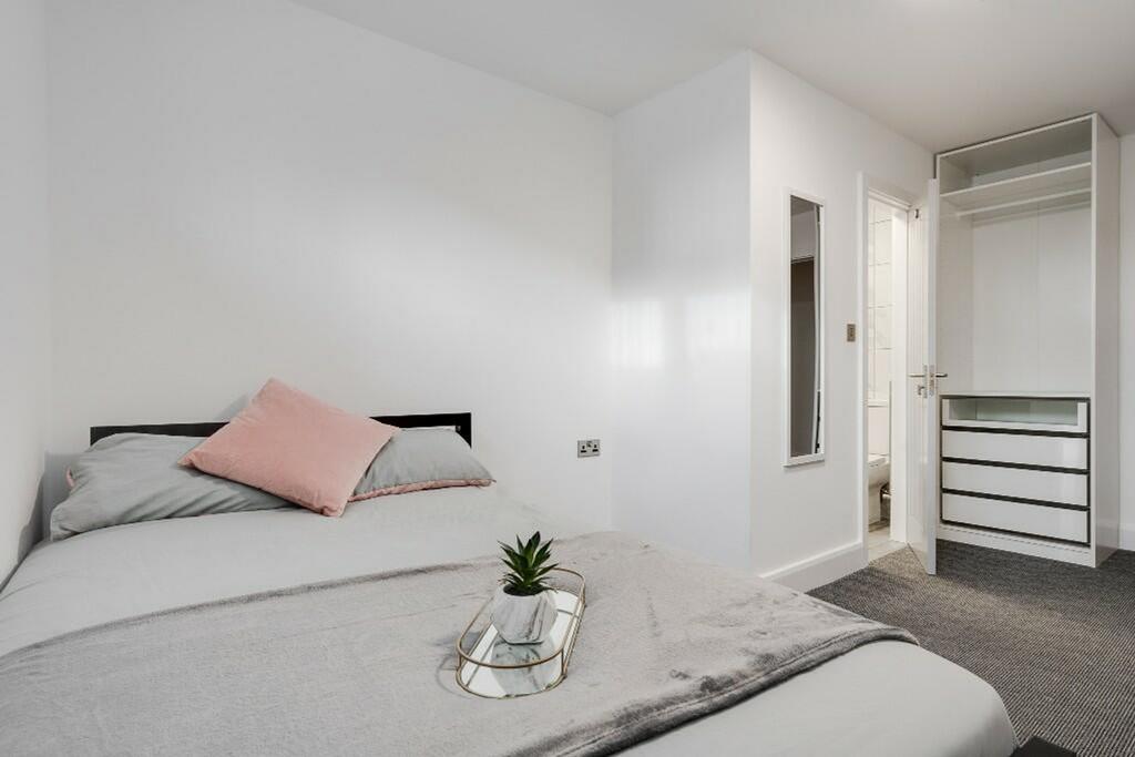 A spacious and inviting double bedroom with mod...