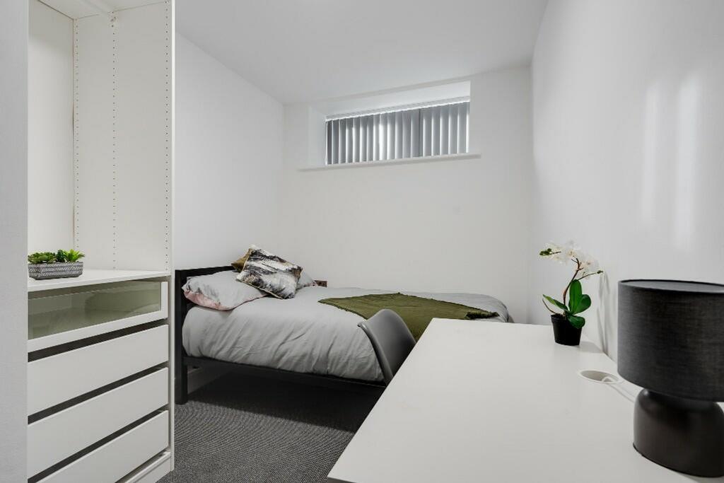 A bright and inviting double bedroom with a sty...