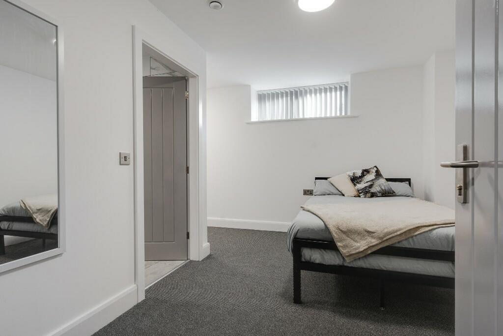 A bright and inviting double bedroom with moder...