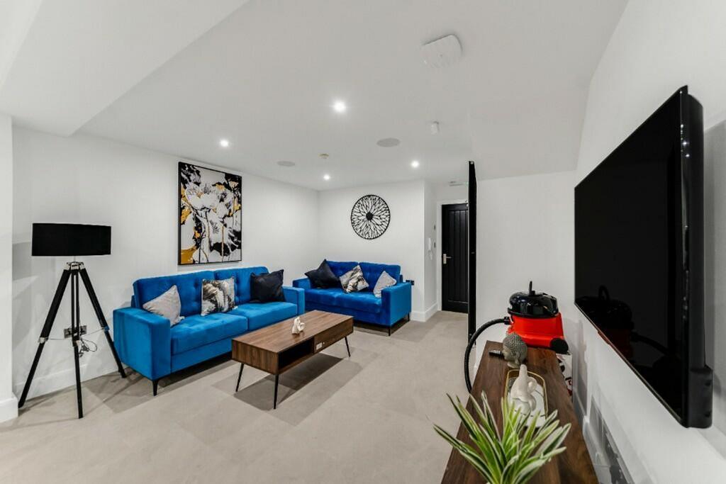 A stylish living room featuring modern blue sof...