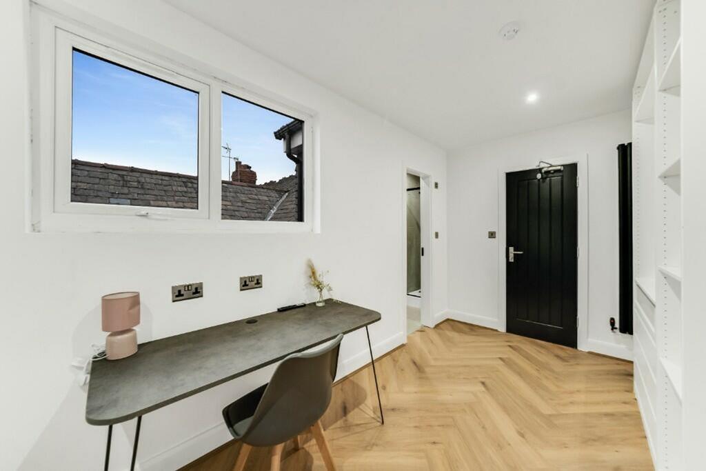 This stylish double bedroom features large wind...