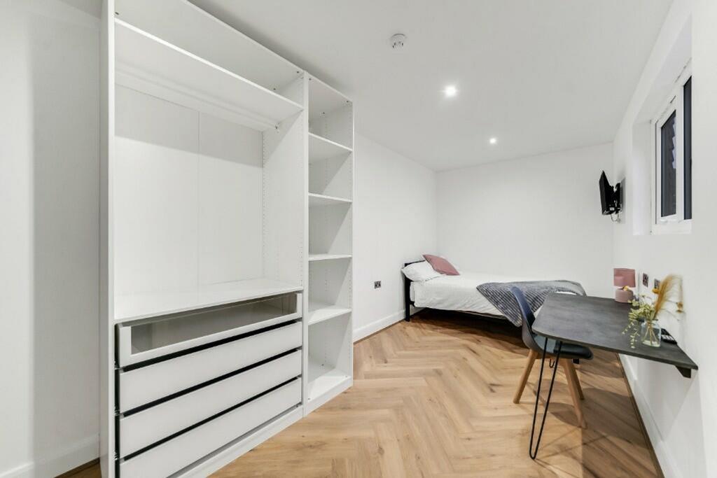 Stylish double bedroom featuring a cozy bed, am...