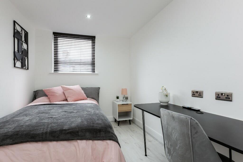 This inviting double bedroom features a cozy be...