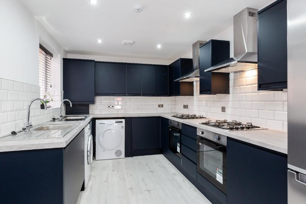 A modern and stylish kitchen featuring sleek ca...