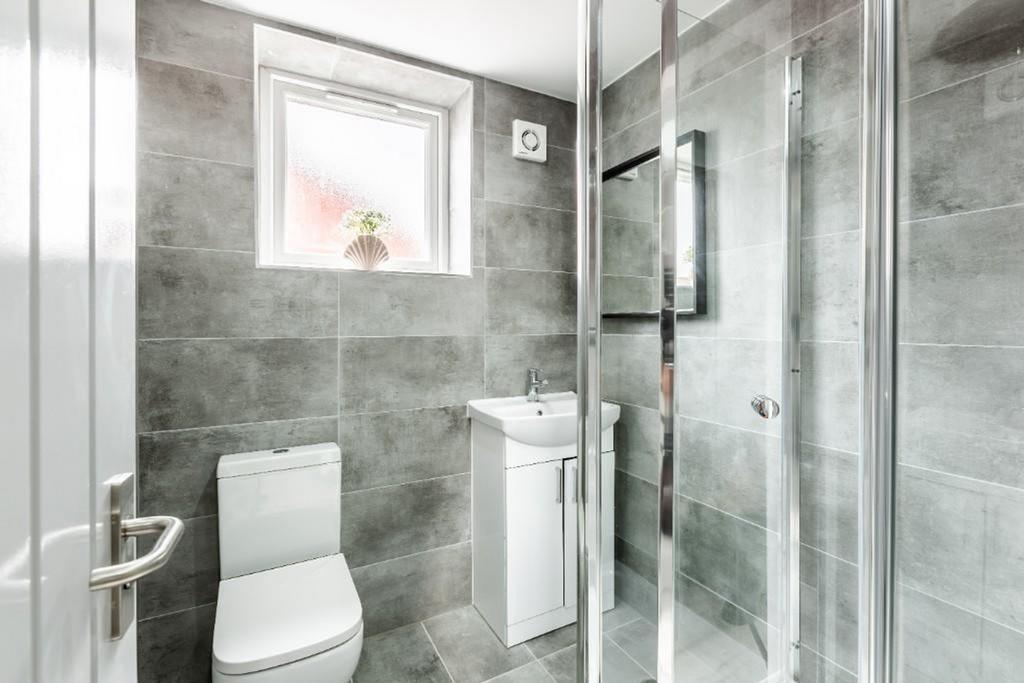 A modern and immaculate bathroom featuring a sp...