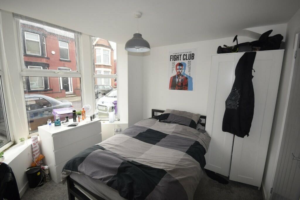 A bright and inviting double bedroom with ample...