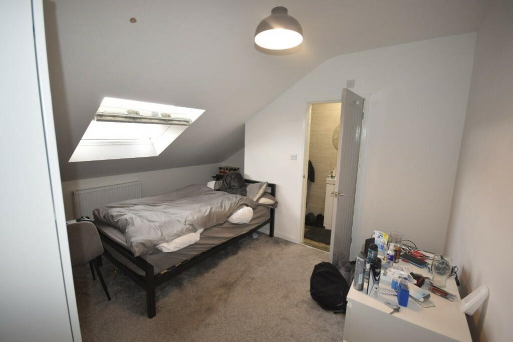 A spacious and inviting double bedroom with ple...