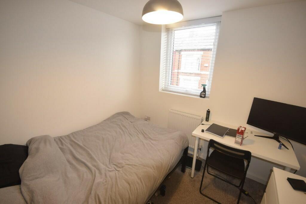 A cozy and well-lit double bedroom, perfect for...