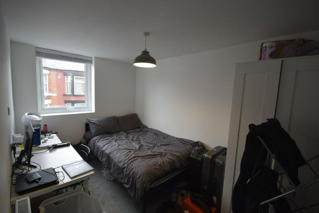 A cozy and well-lit double bedroom with modern ...