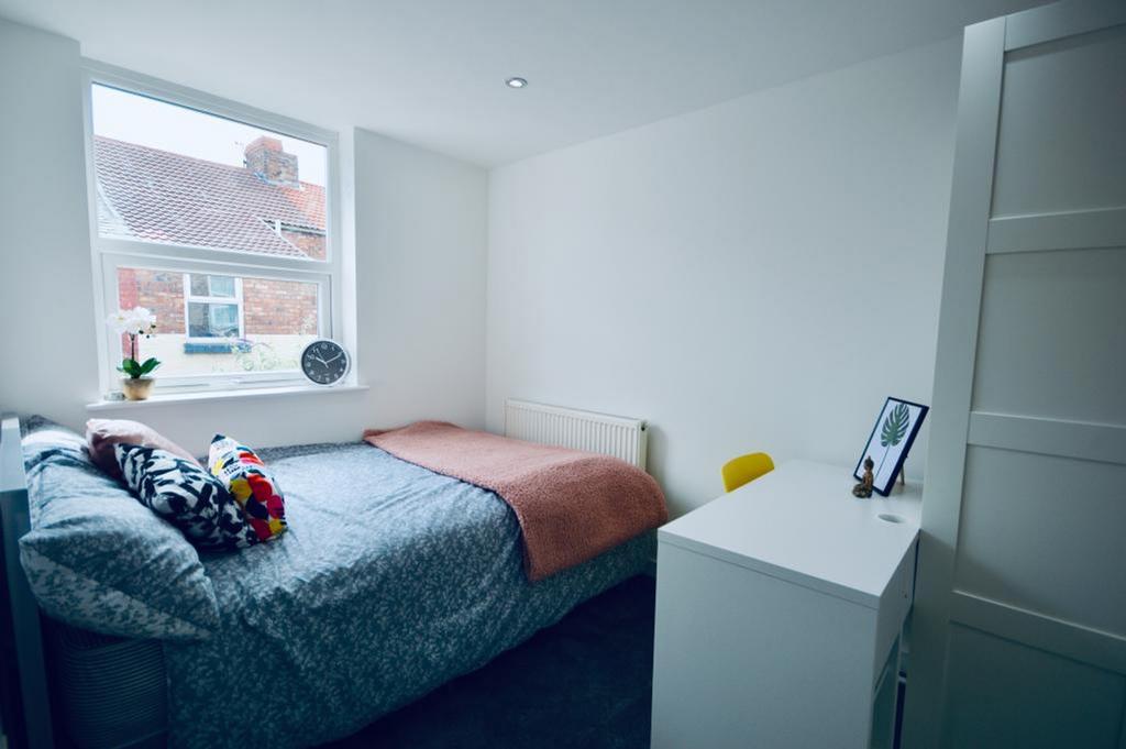 A bright and inviting double bedroom with moder...