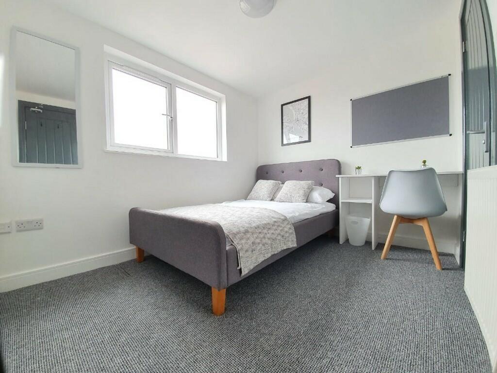 A bright and inviting double bedroom featuring ...