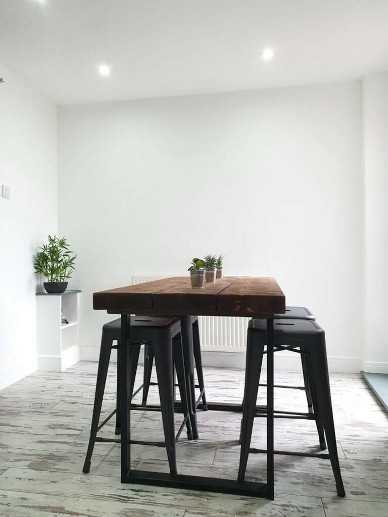 A bright and modern kitchenette with a stylish ...