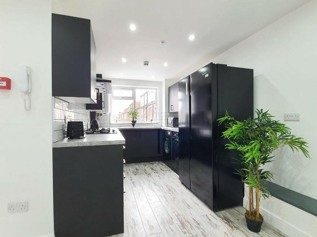 A modern and spacious kitchenette featuring sle...