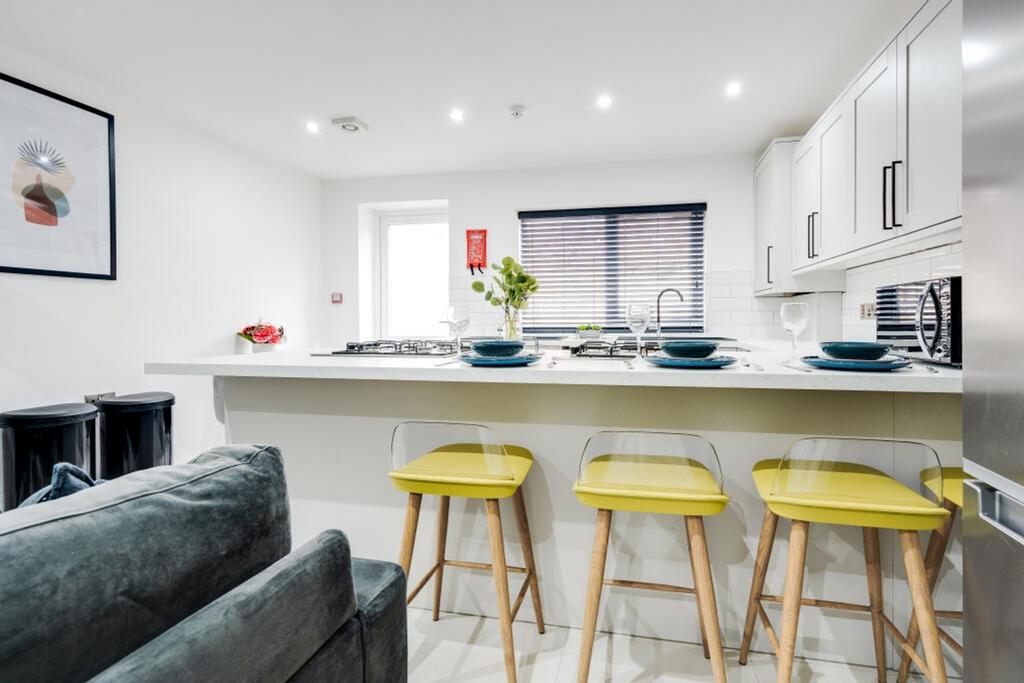 Modern kitchen featuring a stylish island bar w...